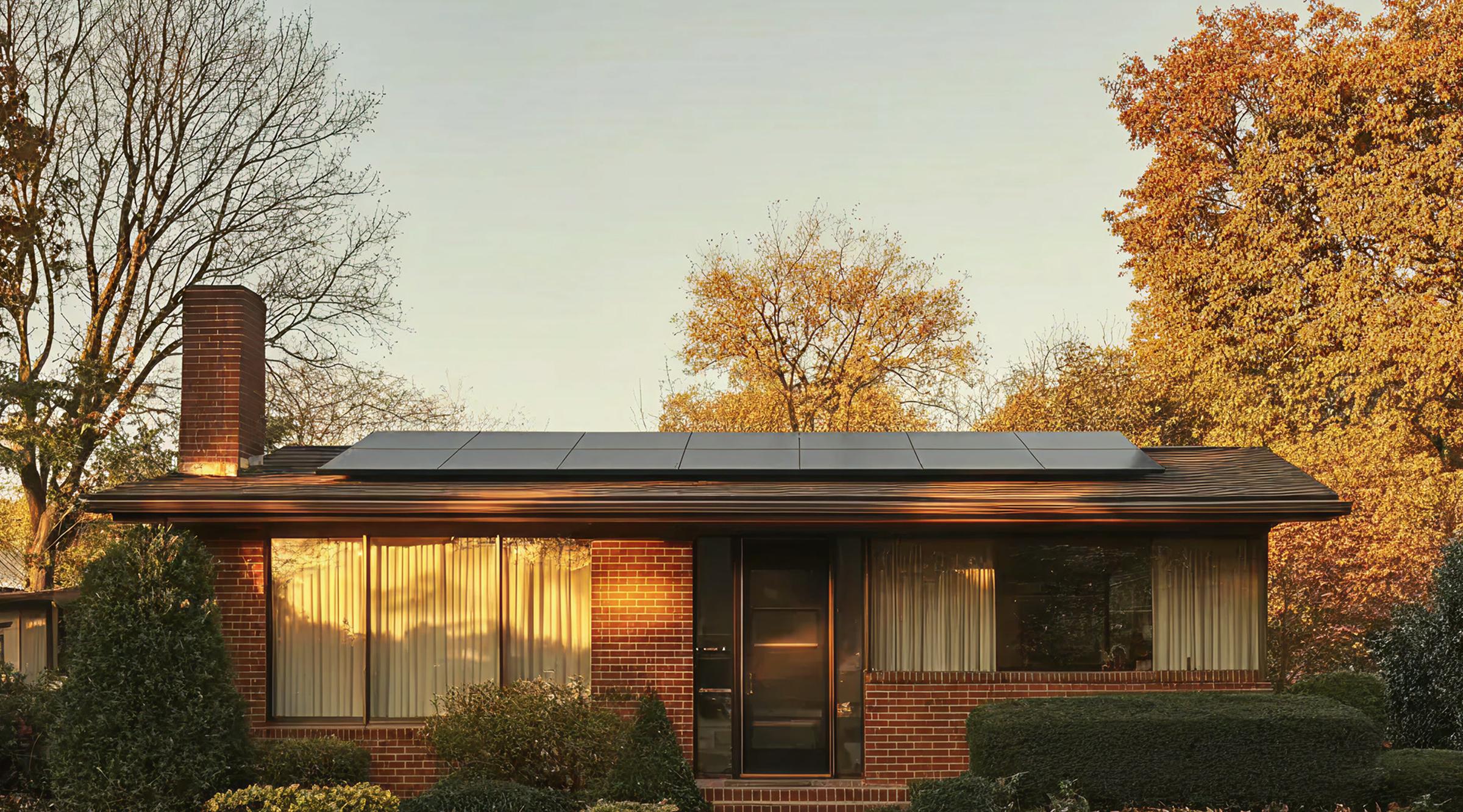 A family home at sunrise with solar panels on the roof