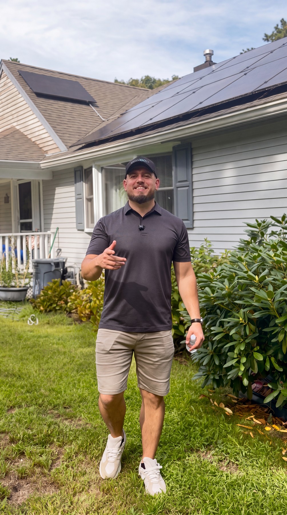 Gabriel Lindemeyer of Ecoloop in front of a home with a rooftop solar array